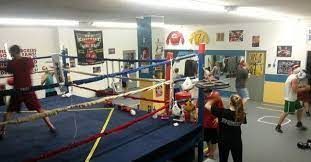 A group of people are boxing in a boxing ring.