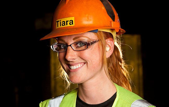 A woman wearing a hard hat with the word tiara on it