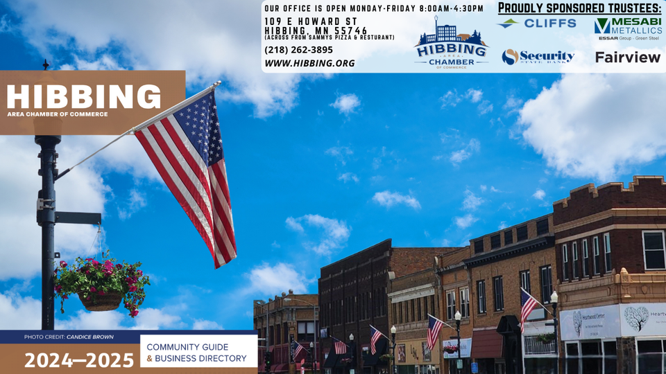 A picture of a city street with an american flag in the foreground.