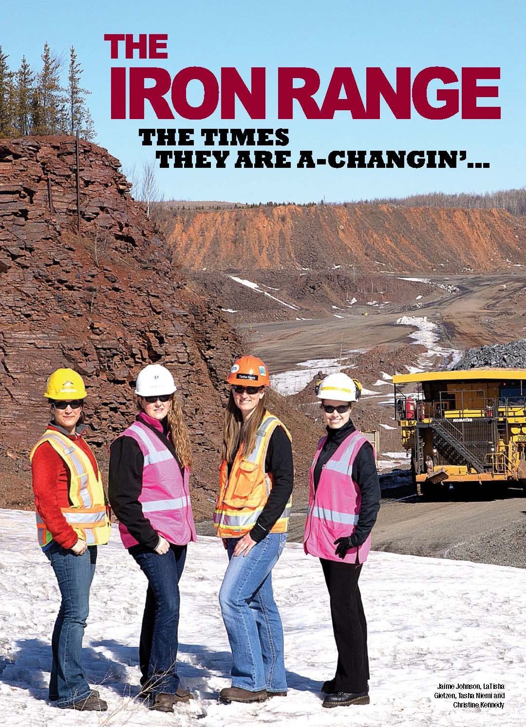 A group of women standing next to each other in front of a large truck.