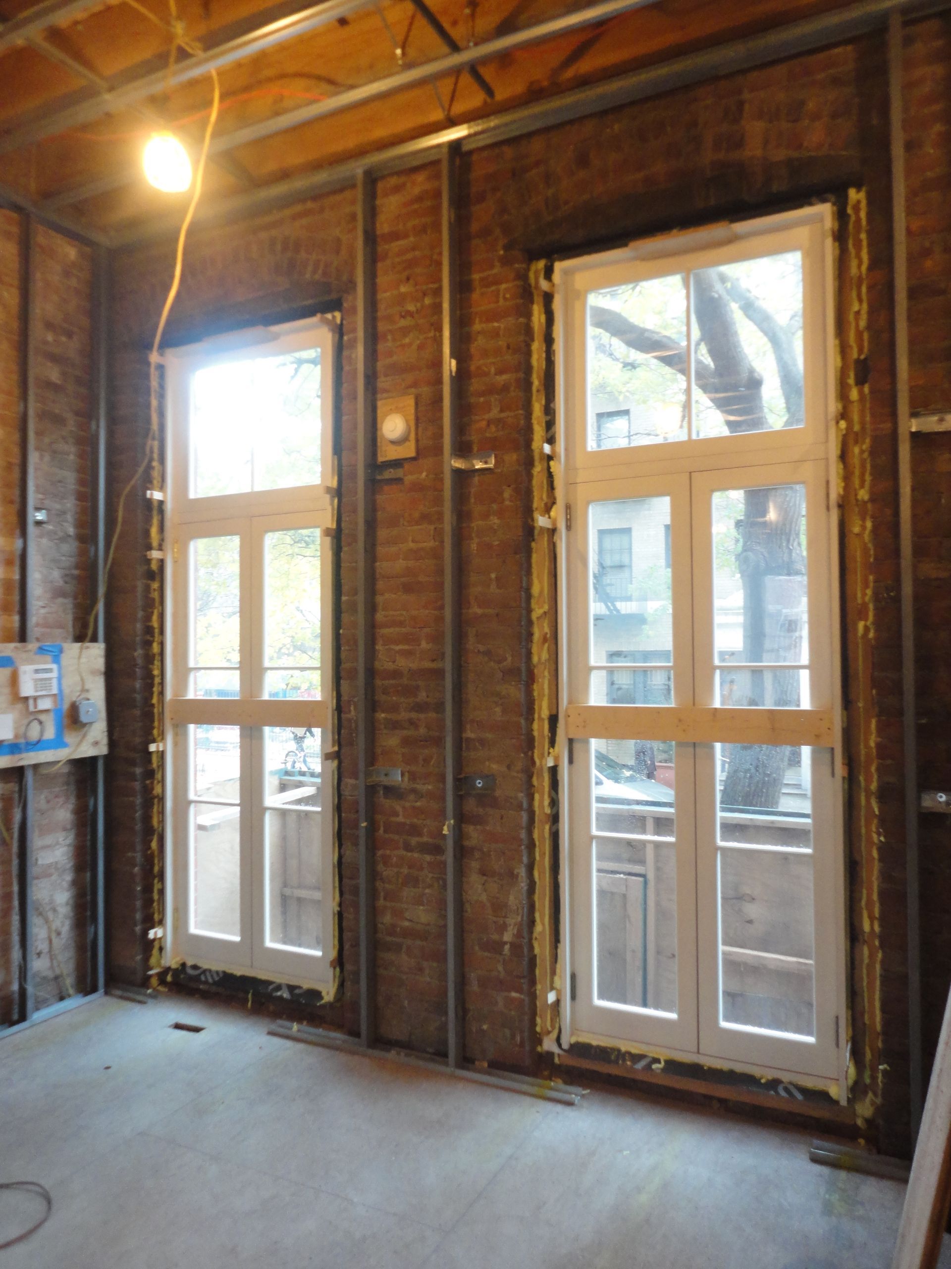 A room with a lot of windows and brick walls