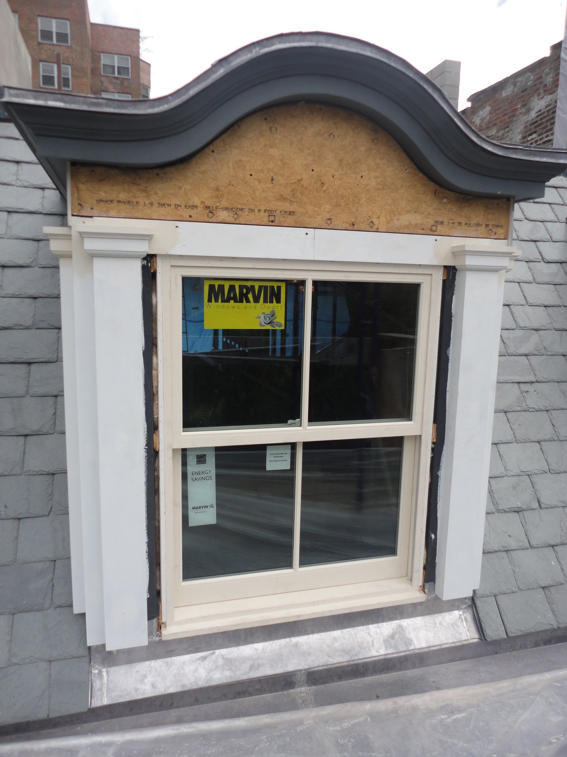 A window with a yellow sign that says marvin on it