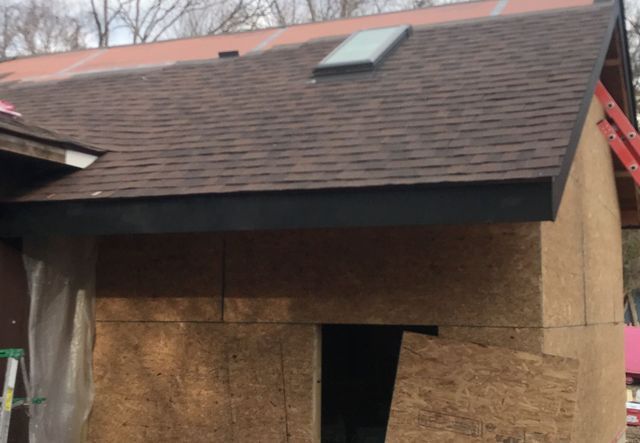 A house with a roof that has a skylight on it