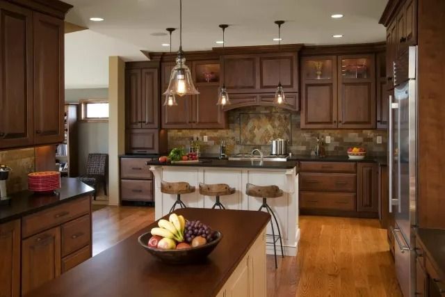 A kitchen with a bowl of fruit on the counter
