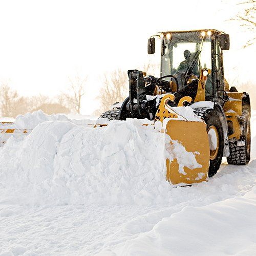 Big Yellow Snow Plow Cleaning a Road — Baldwinsville, NY — Shute Landscaping