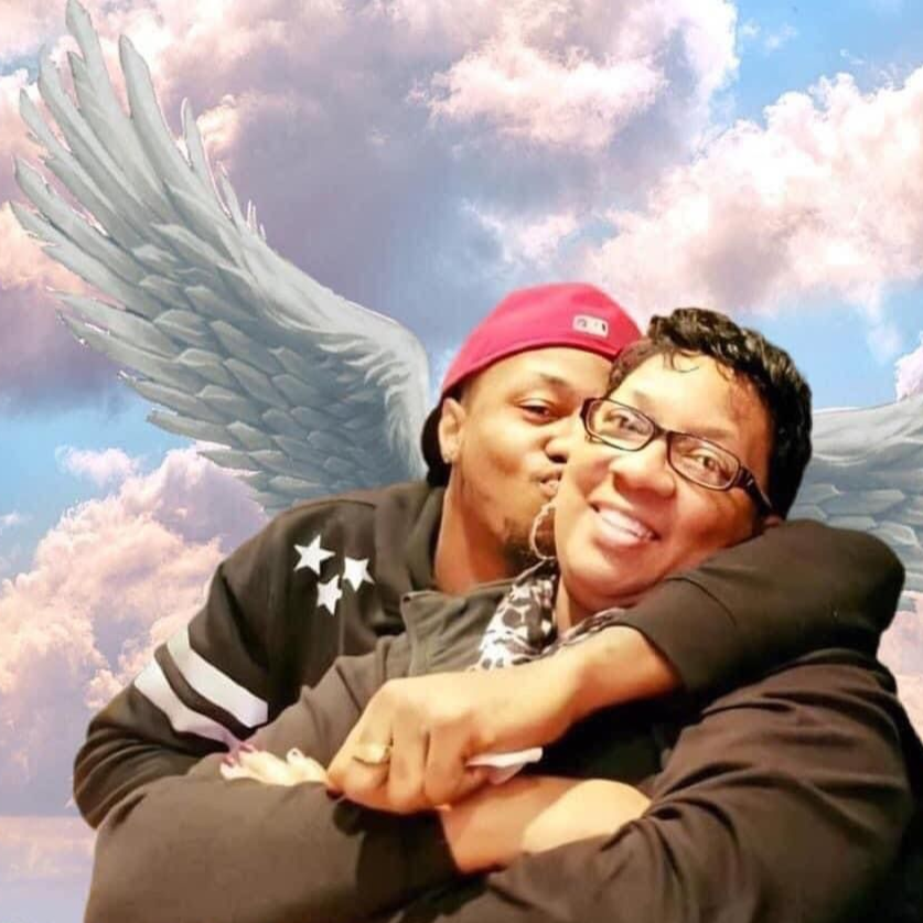 Couple hugging, man kissing woman's cheek. Angel wings superimposed on cloudy sky background.