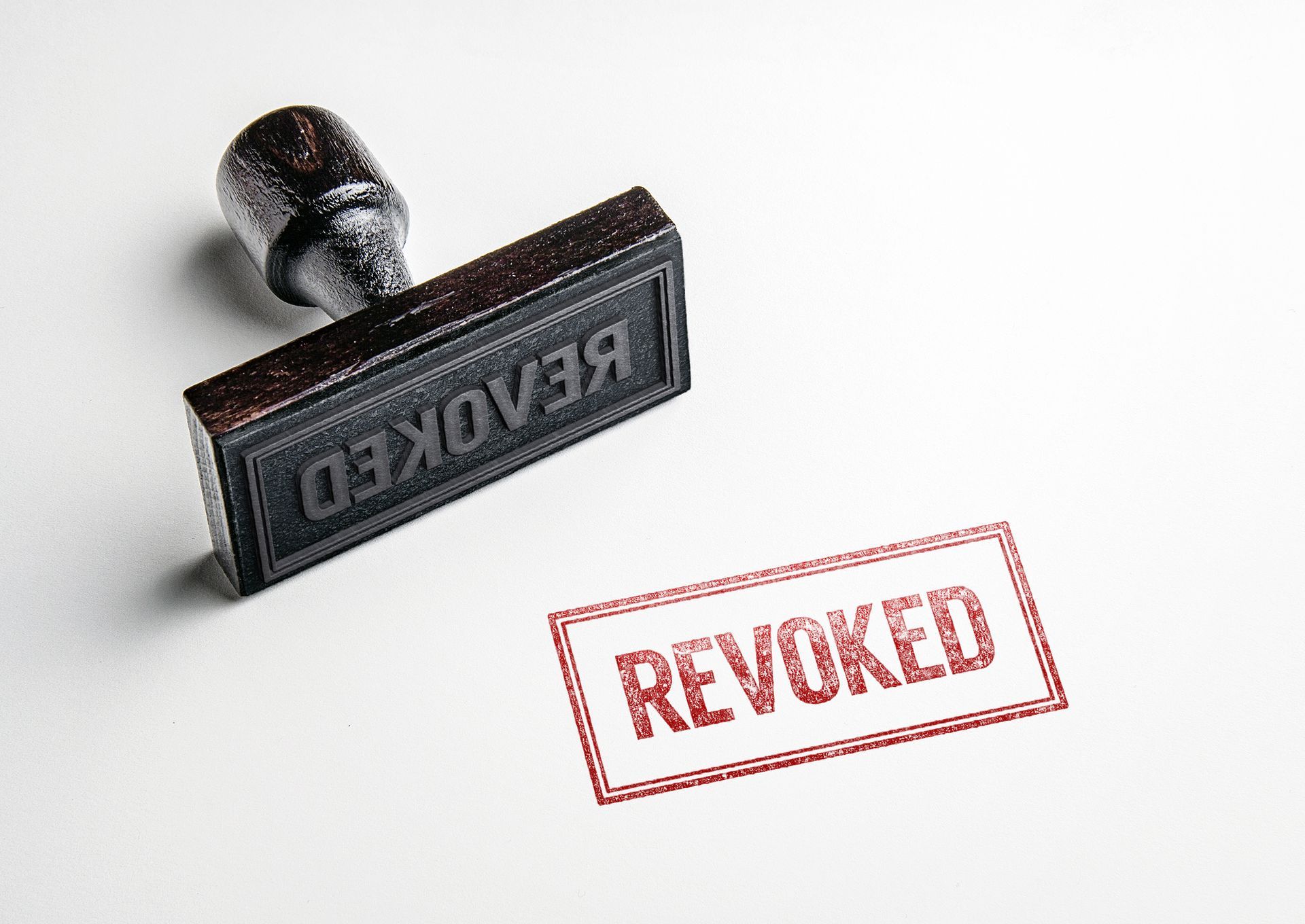 a stamp with the word revoked written on it .