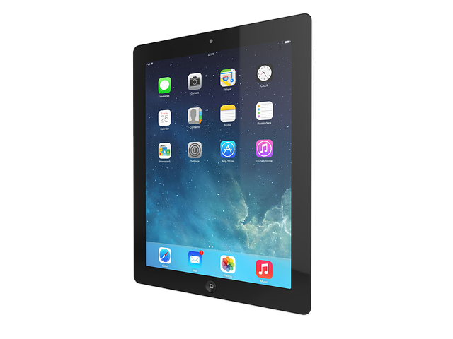 A black iPad angled to the side, displaying an iOS home screen with various app icons on a blue abstract background.