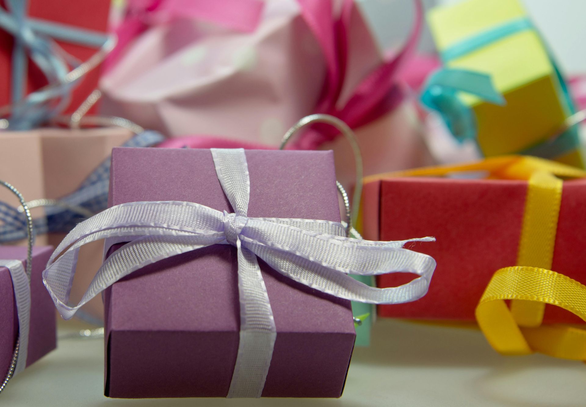 Gift boxes and popular gadgets are arranged for holiday shopping.