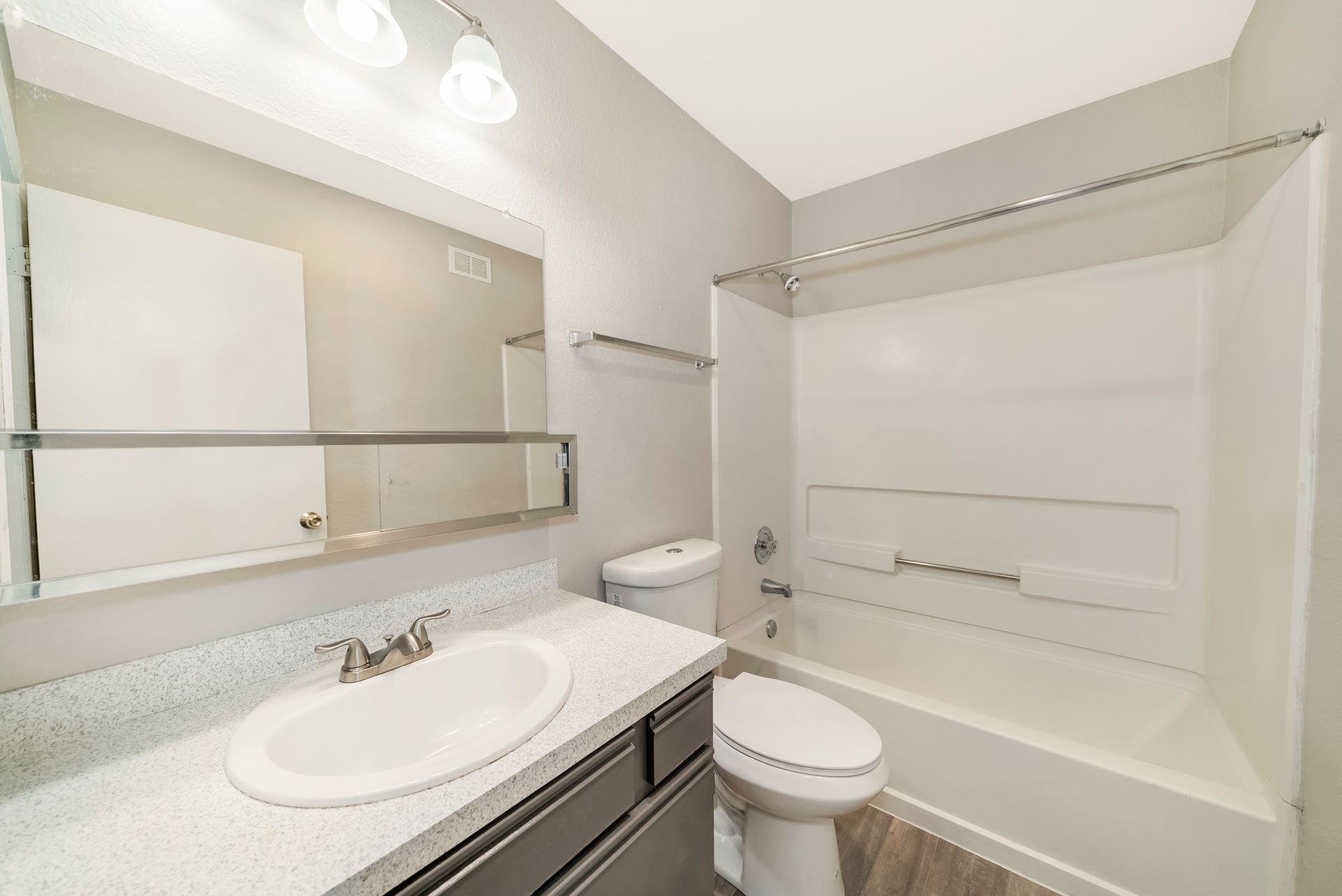 A bathroom with a toilet , sink , and bathtub.