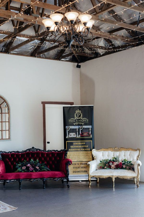 A Room With Two Couches and a Sign on the Wall — Prim n Proper Event Hire in Palmview, QLD