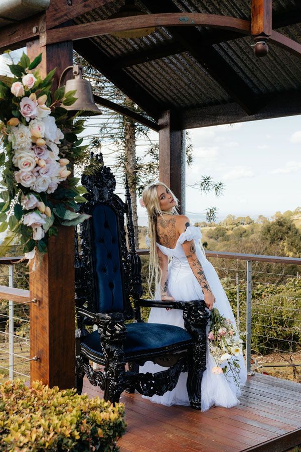 A Bride in a White Dress is Sitting on a Black Throne — Prim n Proper Event Hire in Palmview, QLD