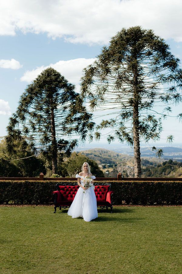 A Bride in a White Dress is Holding a Bouquet of Flowers — Prim n Proper Event Hire in Palmview, QLD