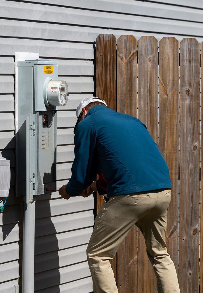 A wooden fence is sitting on top of a lush green field.