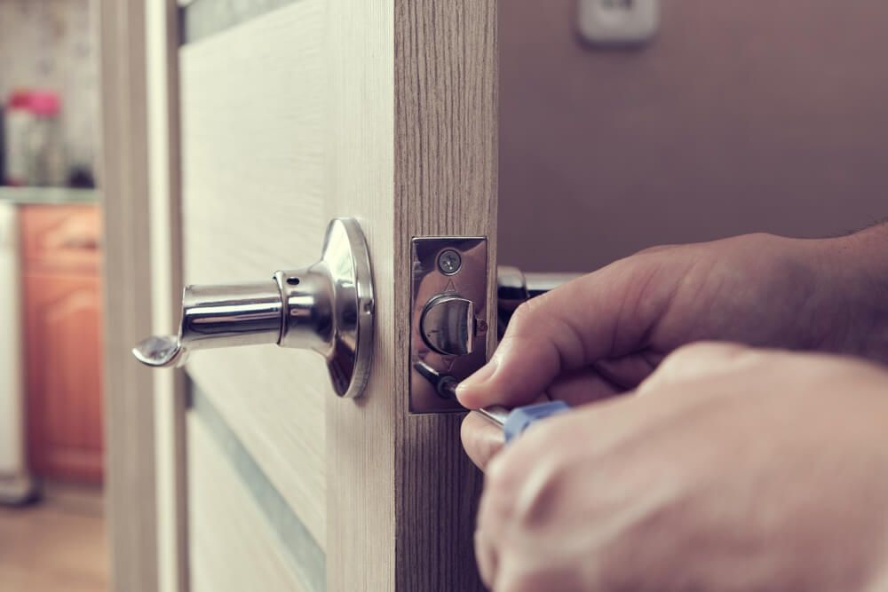 Fixing a Door Handle with a Screwdriver — Coast 2 Coast Locksmiths in Coolum Beach, QLD