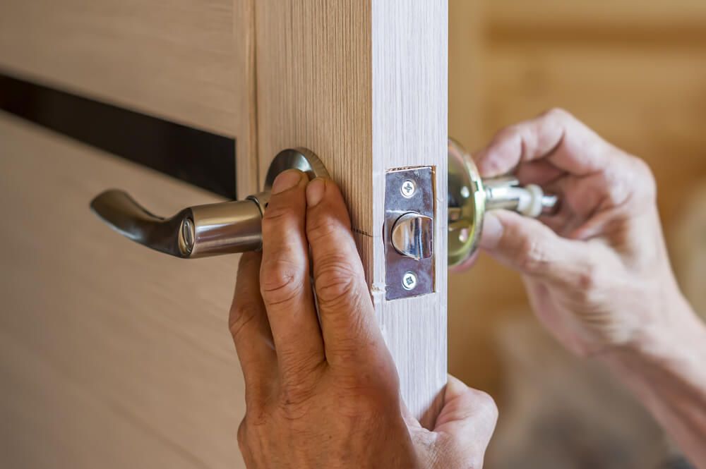 man installing the residential locksmith