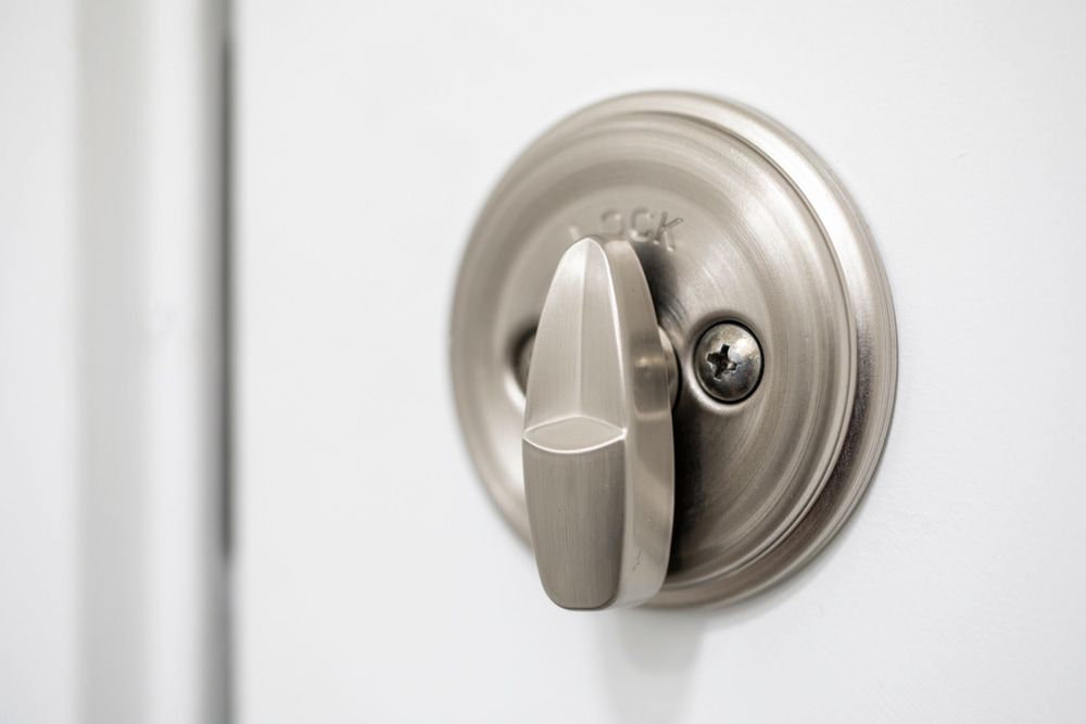 Silver Door Handle and Lock on White Door — Coast 2 Coast Locksmiths in Pelican Waters, QLD