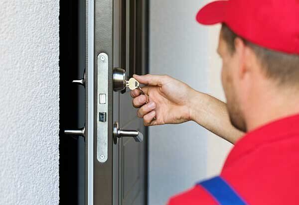 Locksmith Working in Red Uniform — Key Replacements in Sunshine Coast, QLD