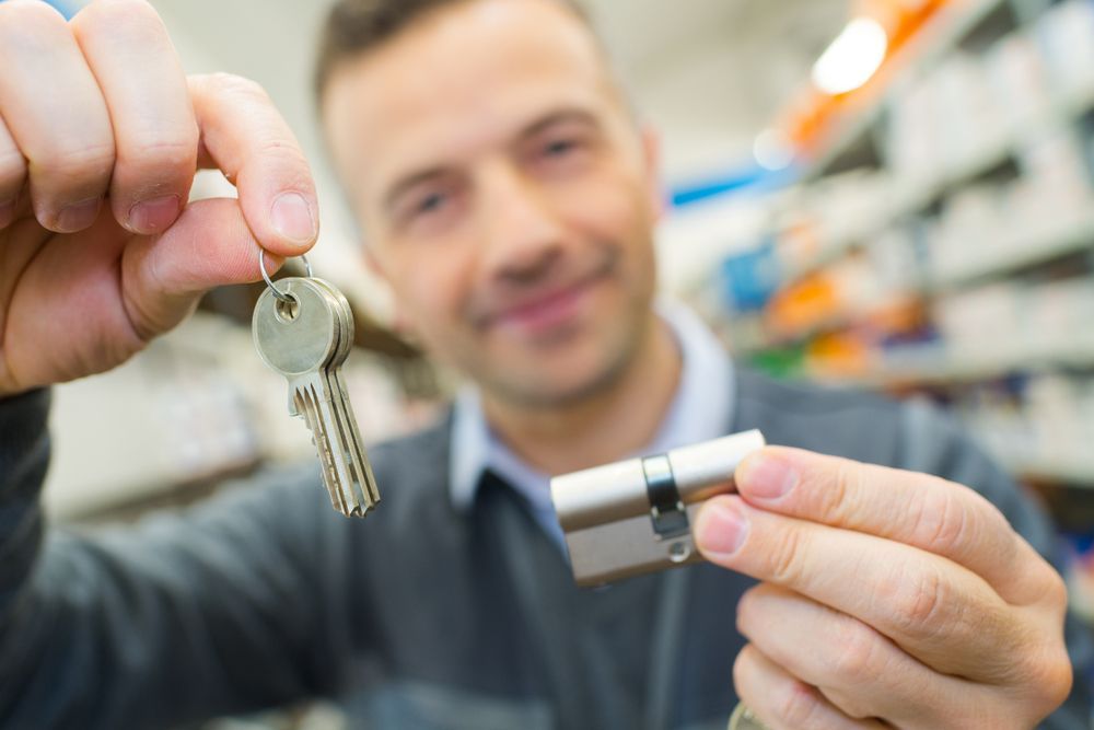 Locksmith Holding Locking Mechanism and Key — Coast 2 Coast Locksmiths in Nambour, QLD
