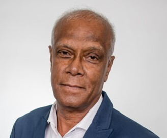 Portrait of a man in a blue blazer and white shirt against a light background