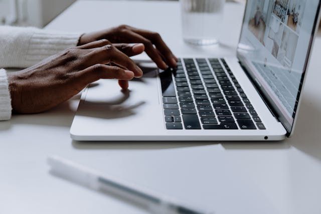 person typing on laptop