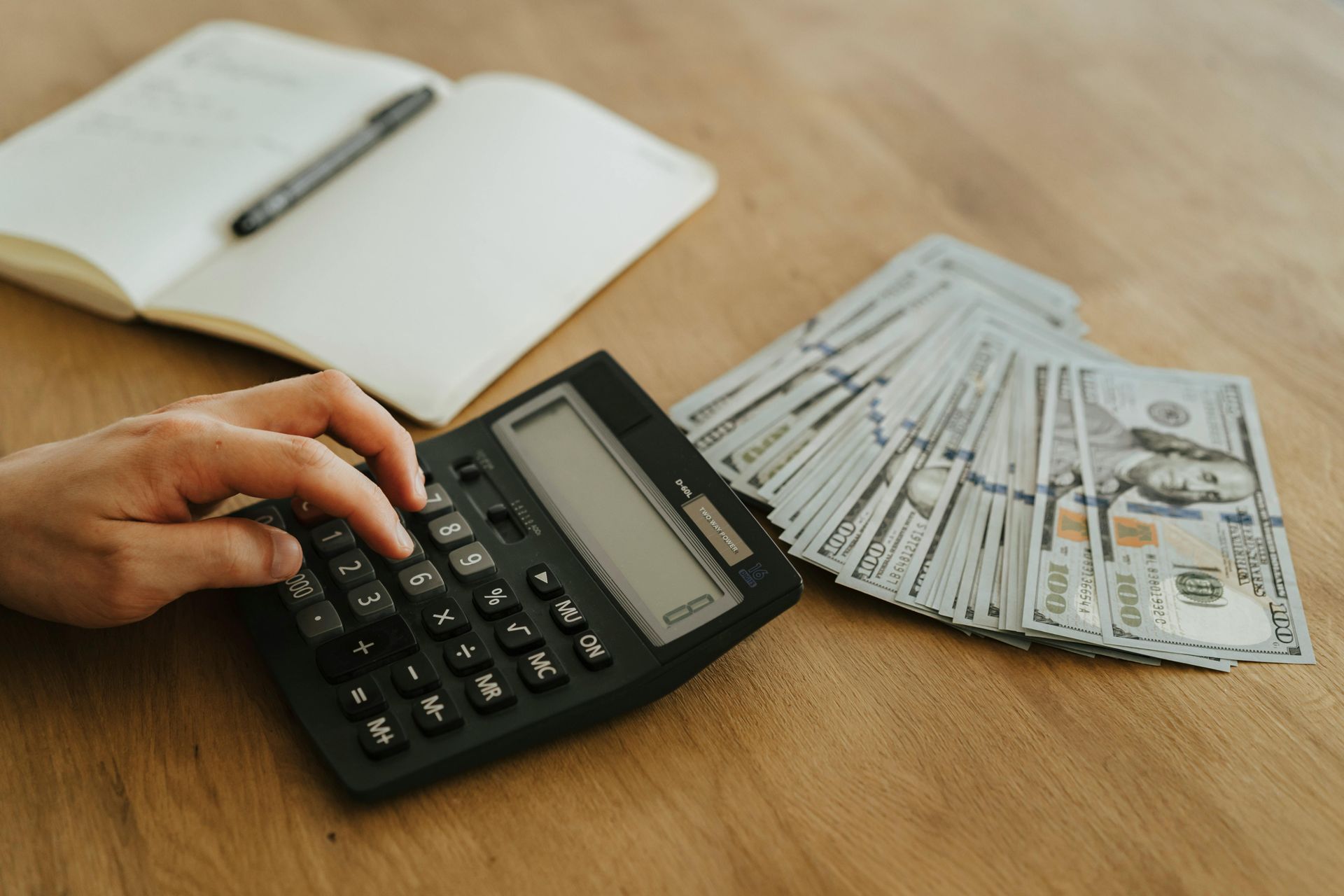 calculator with cash and a notebook 