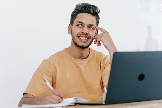 person smiling with a computer