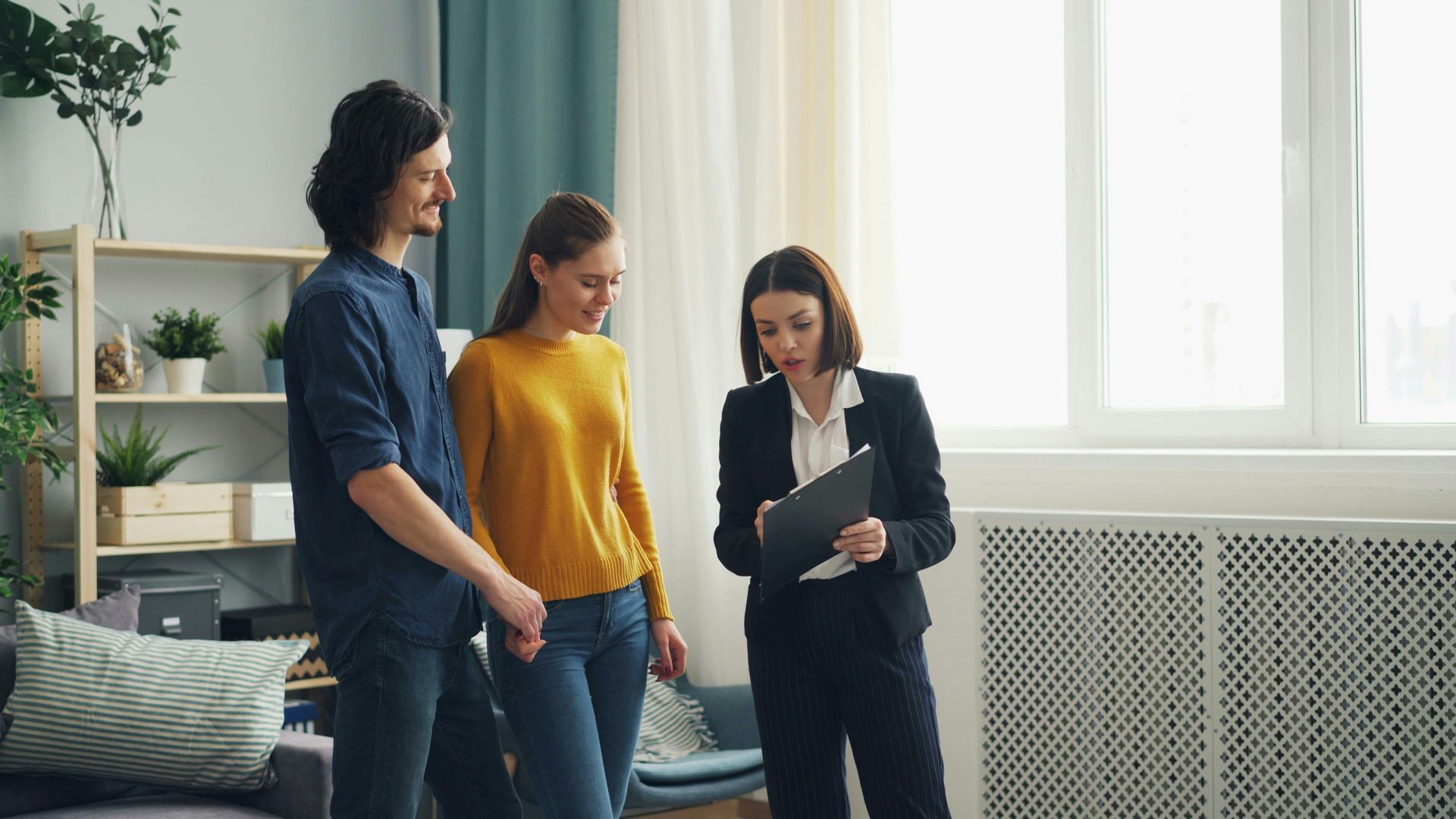 three people looking at clipboard