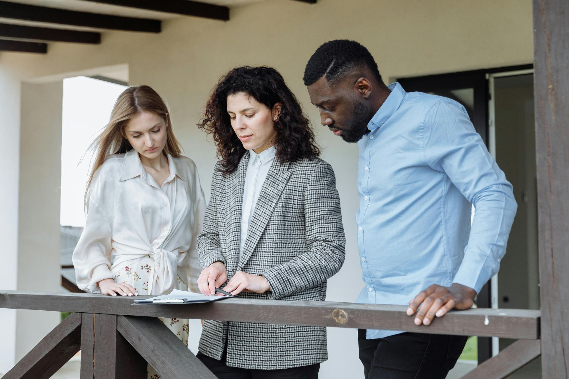 three people looking at documents