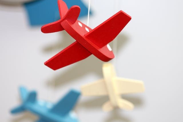 red-toy-airplane-hanging-from-a-string