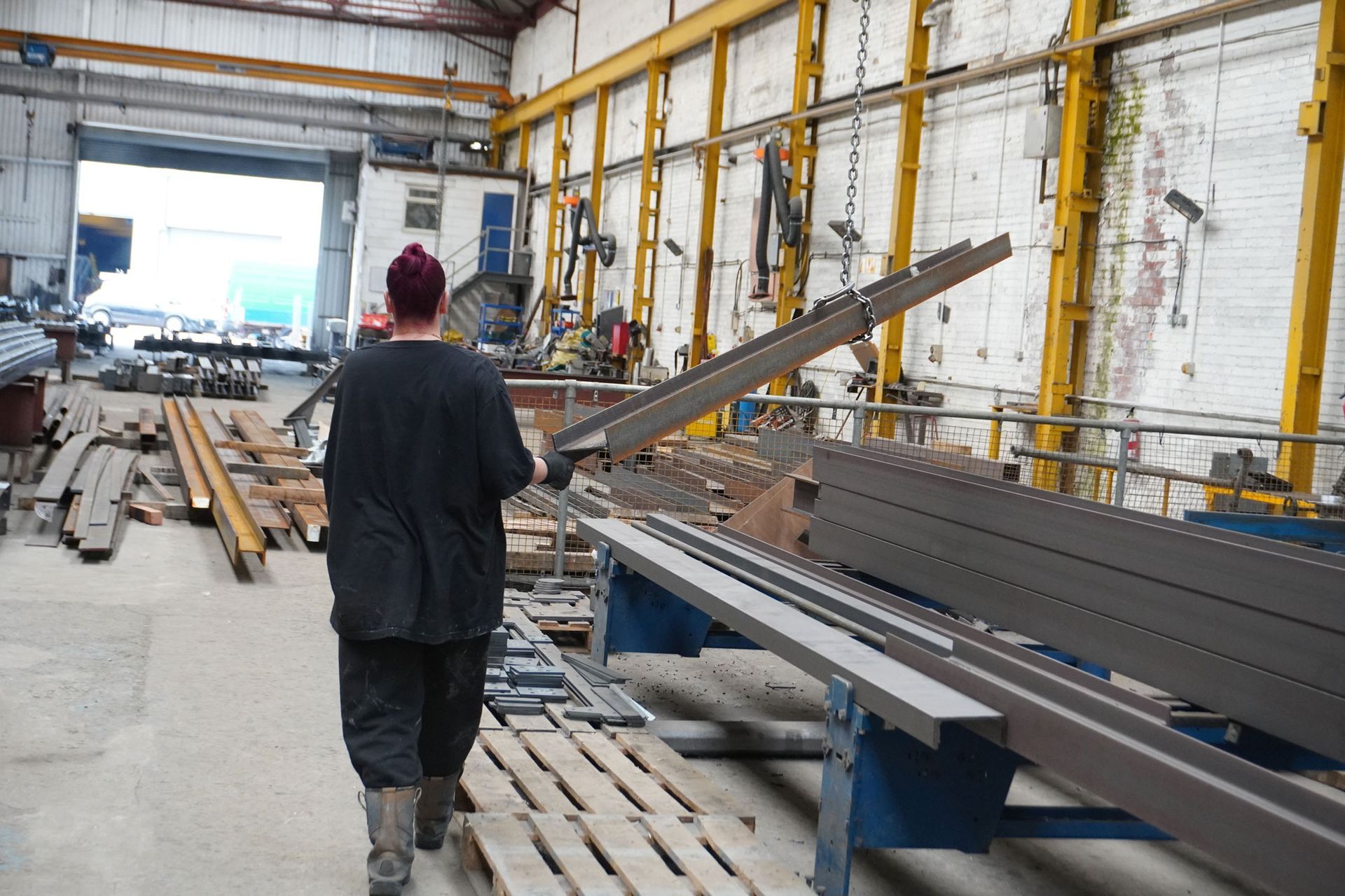 Person moving fabricated steel beam