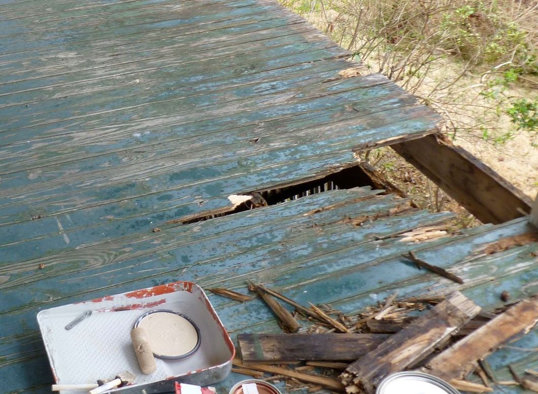 A box of food is sitting on top of a blue roof.