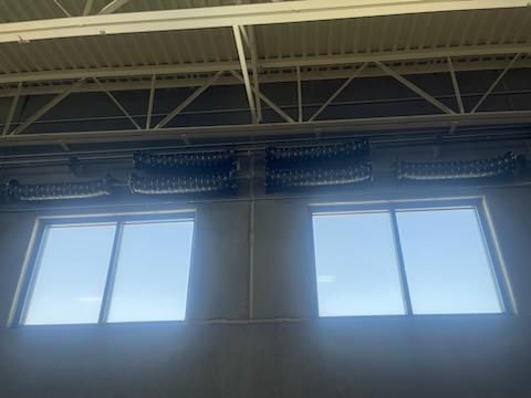 There are two windows in the ceiling of a building.