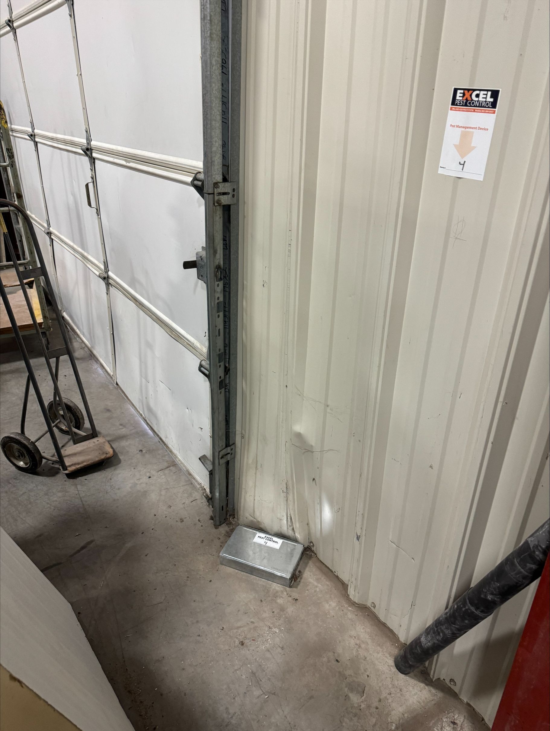 A garage door with a box on the ground next to it.