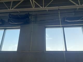 A room with a lot of windows and a blue sky in the background.