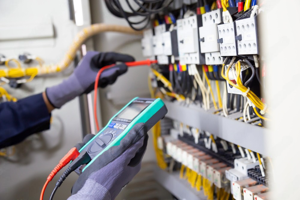 Person installing electrical sockets in a newly constructed apartment.