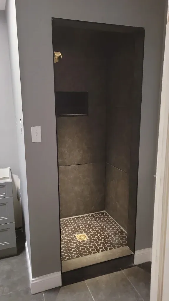 A bathroom with a walk in shower and a door.