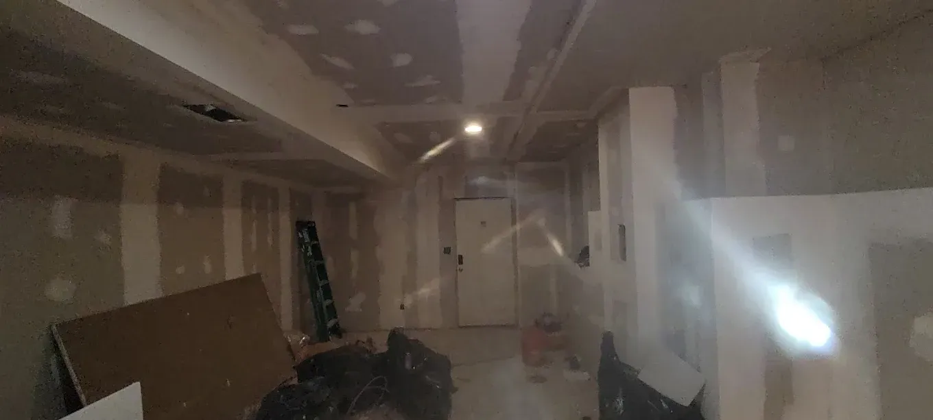 A room with a lot of boxes on the floor and a light on the ceiling.