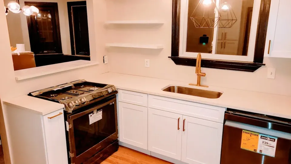 A kitchen with a stove , sink , and dishwasher.