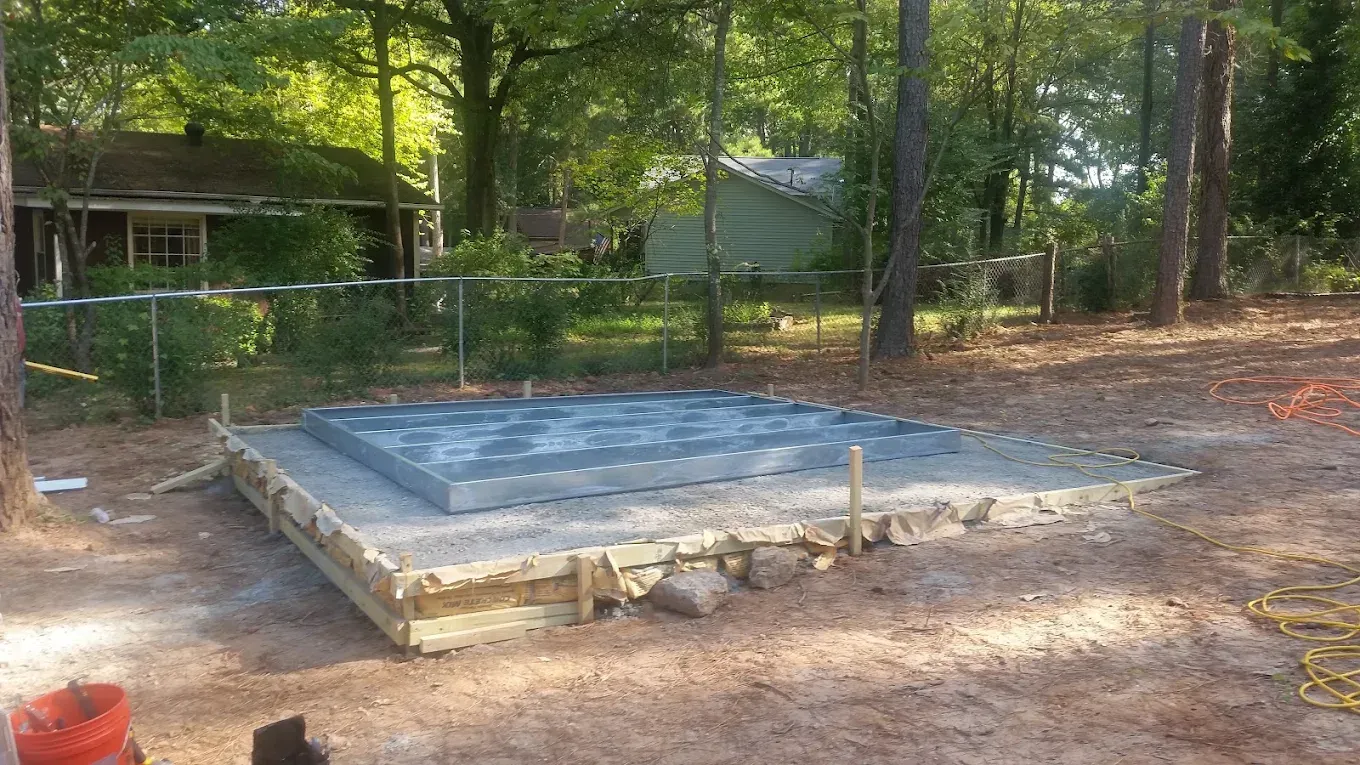 A concrete slab is sitting in the middle of a dirt field.