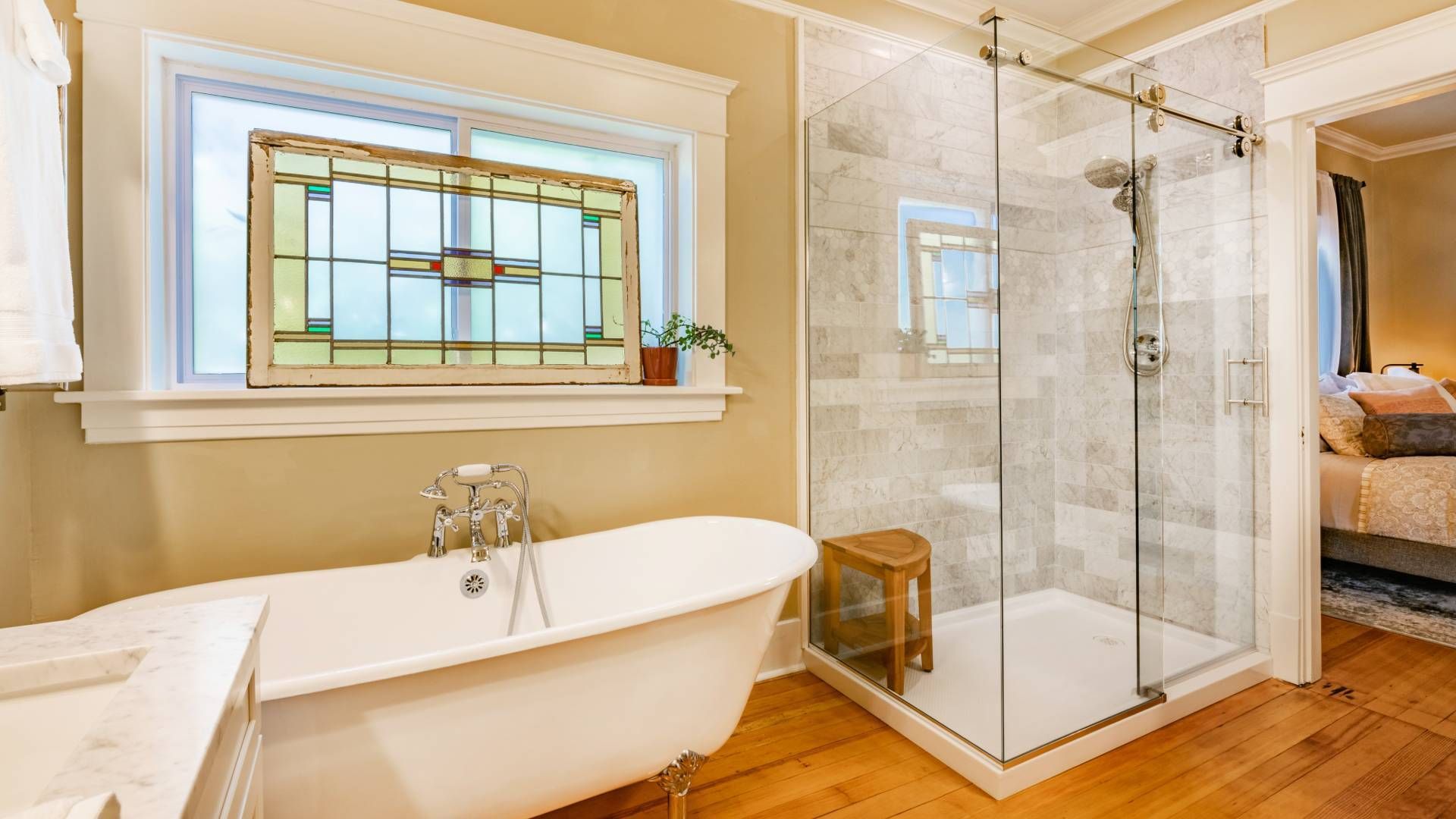 A bathroom with a bathtub and a walk in shower.