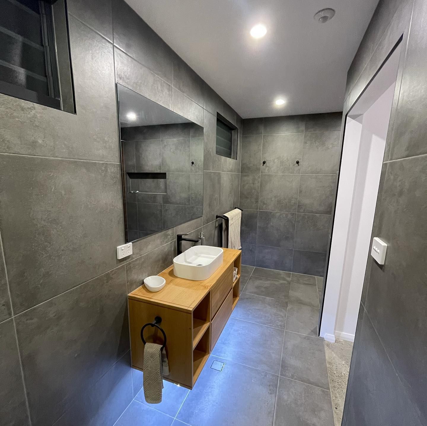 A Bathroom With a Sink, Mirror, and Towel Rack 