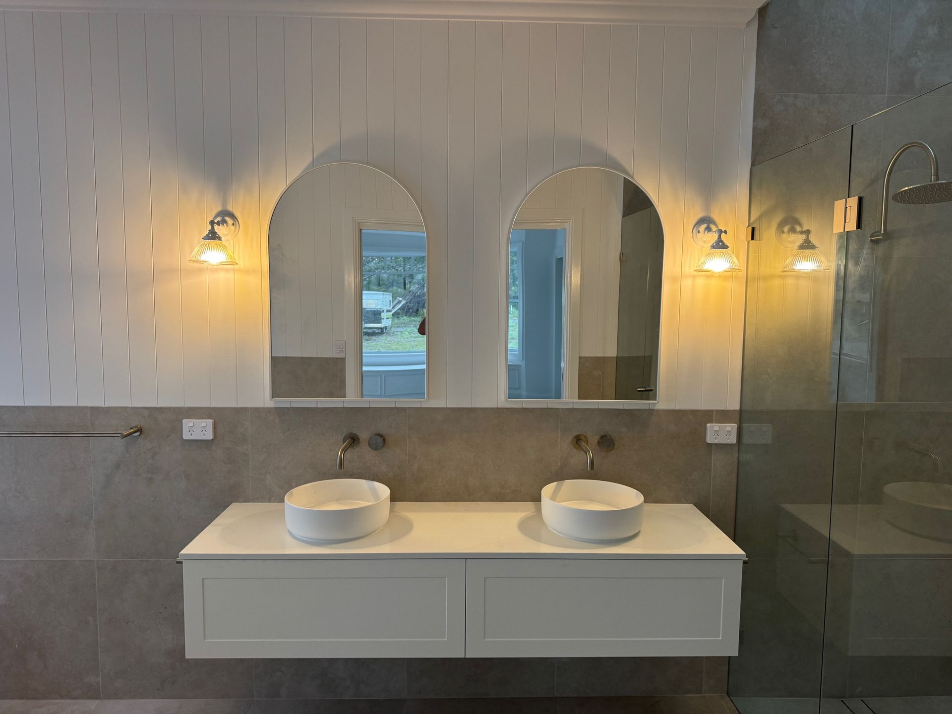 A kitchen with a large island and three stools — Anderson Electrical & Air in Taree, NSW