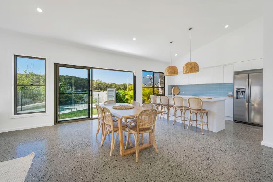An Electrician is Using a Multimeter to Test a Circuit Board — Anderson Electrical & Air in Taree, NSW