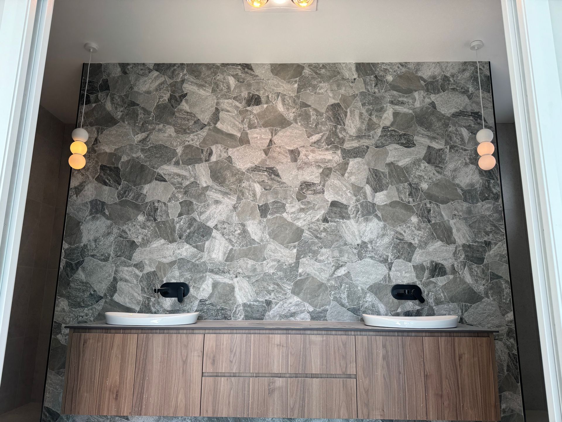 A Man is Fixing a Refrigerator With a Screwdriver — Anderson Electrical & Air in Old Bar, NSW