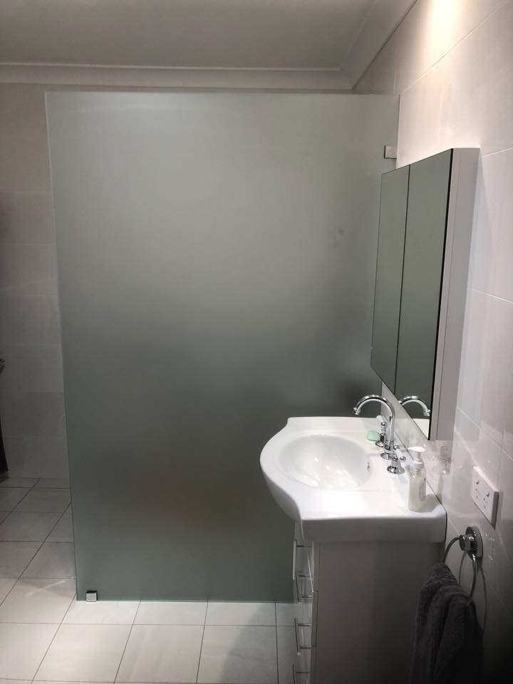 Frosted Shower Screen Beside Vanity Area — Glazing Service in Albion Park, NSW