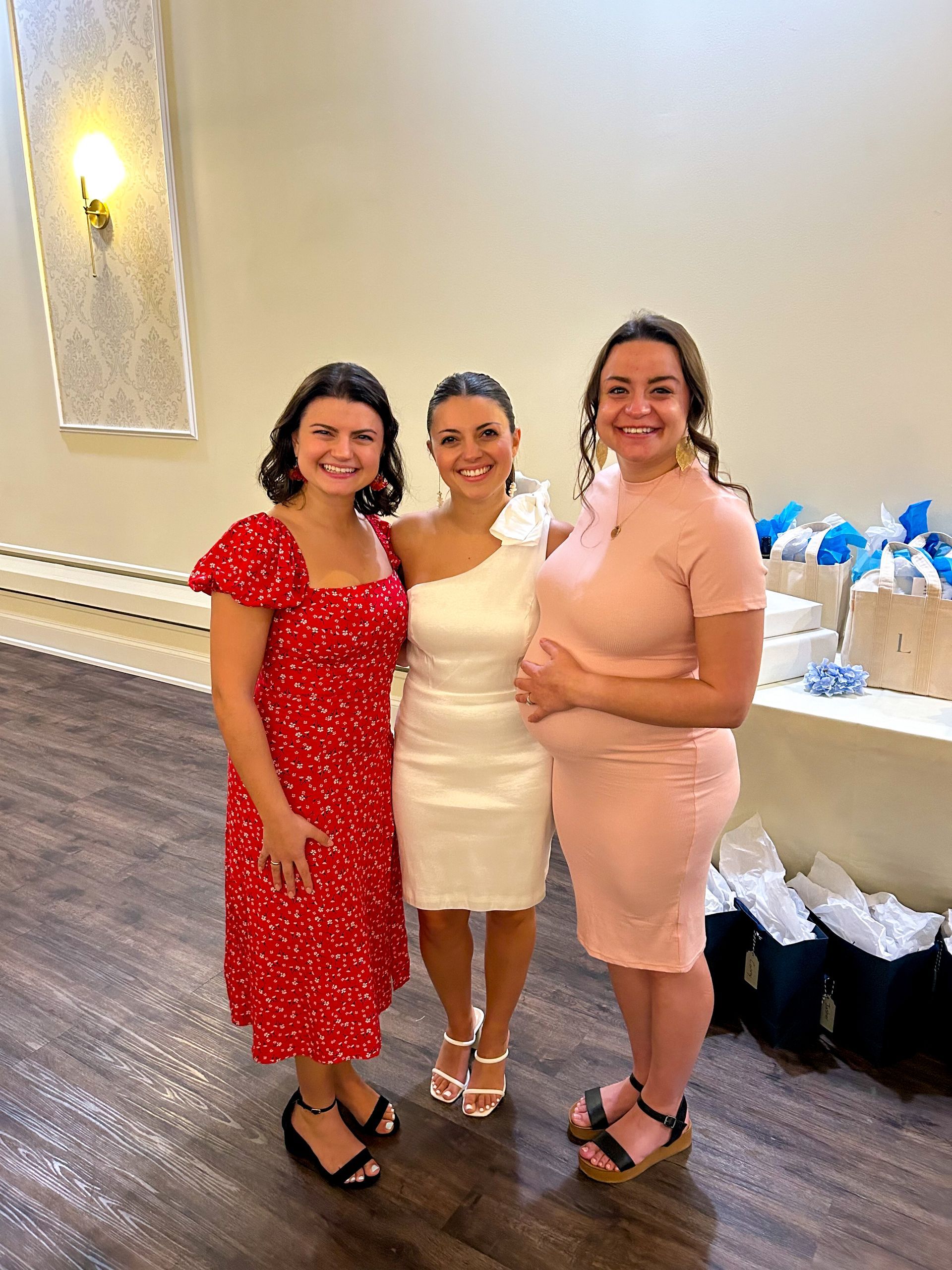 Three women are posing for a picture together in a room.
