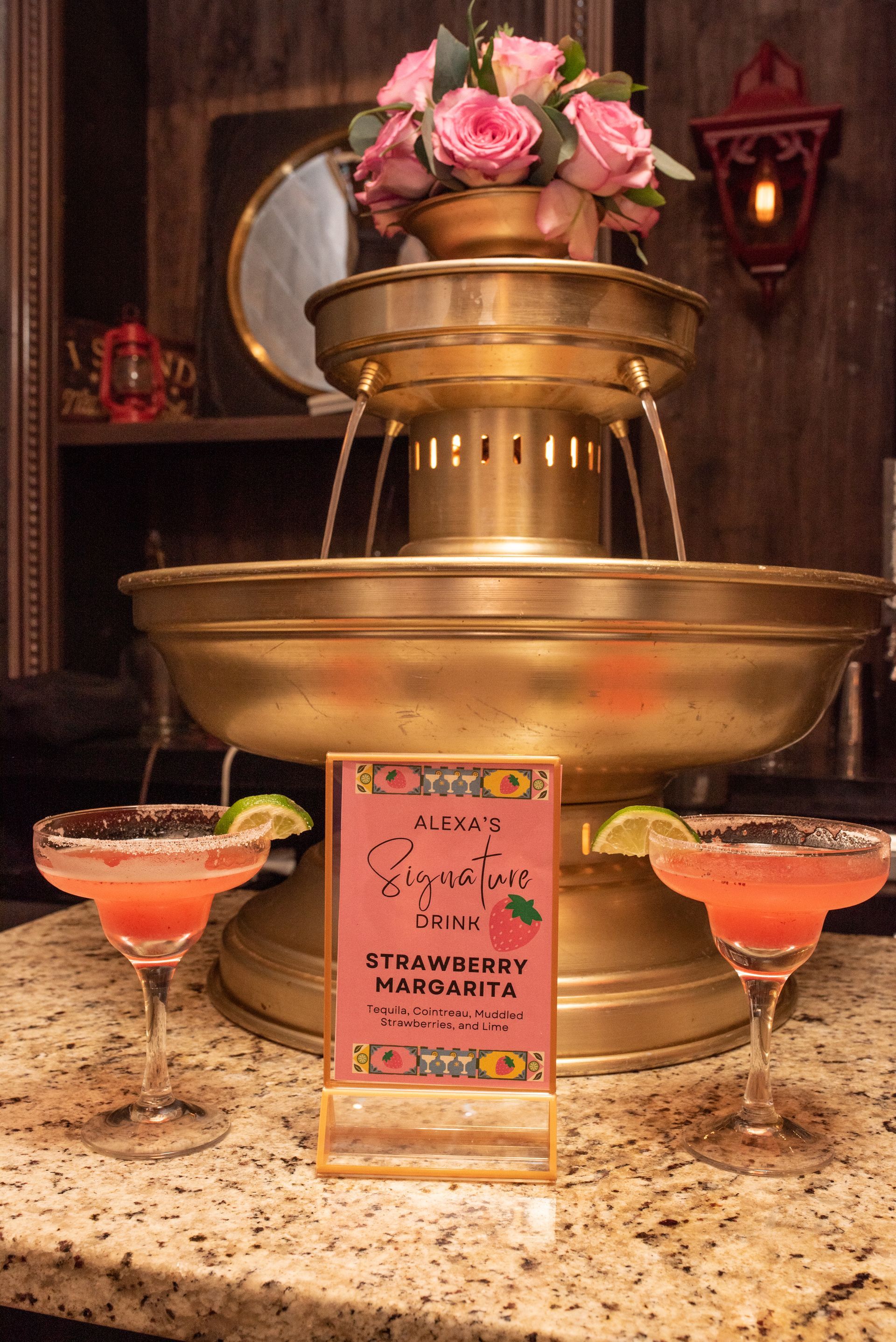 A fountain with two glasses of margarita next to it