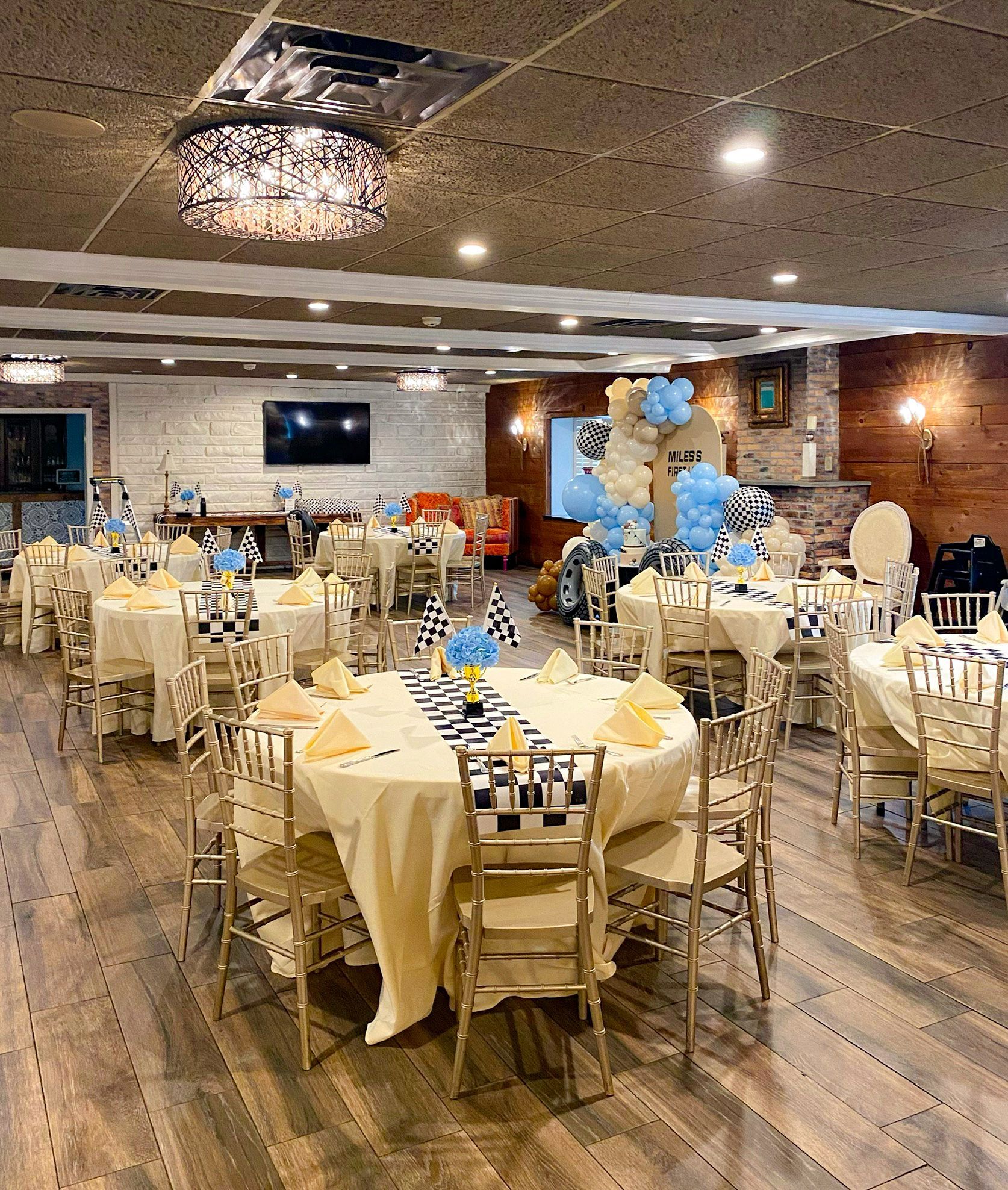 A large room with tables and chairs set up for a baby shower.