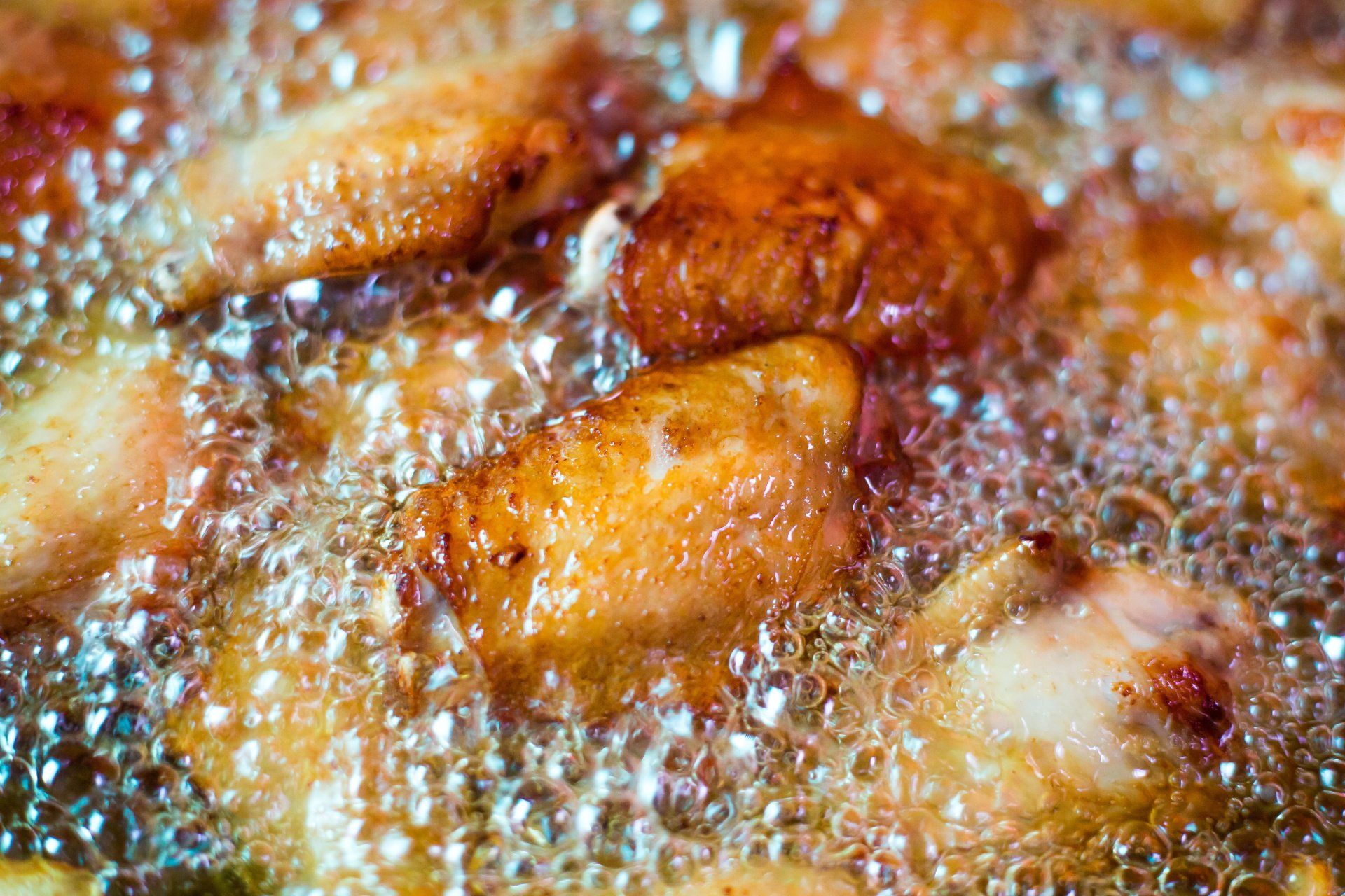 chicken wings in fryer oil